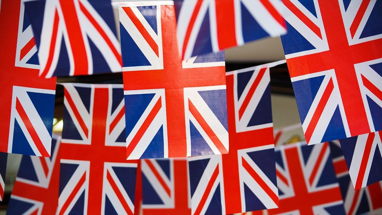 A group of entrepreneurs collaborating in a vibrant startup space, illustrating Britain's efforts to foster innovation and reduce reliance on foreign entities