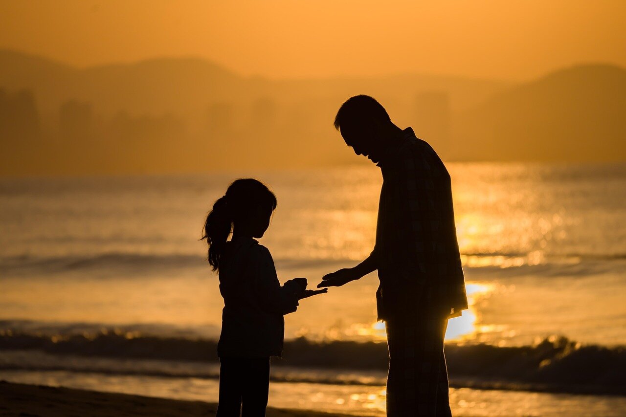 A father sharing a candid moment with his teenage son, reflecting the complexities and challenges of their relationship