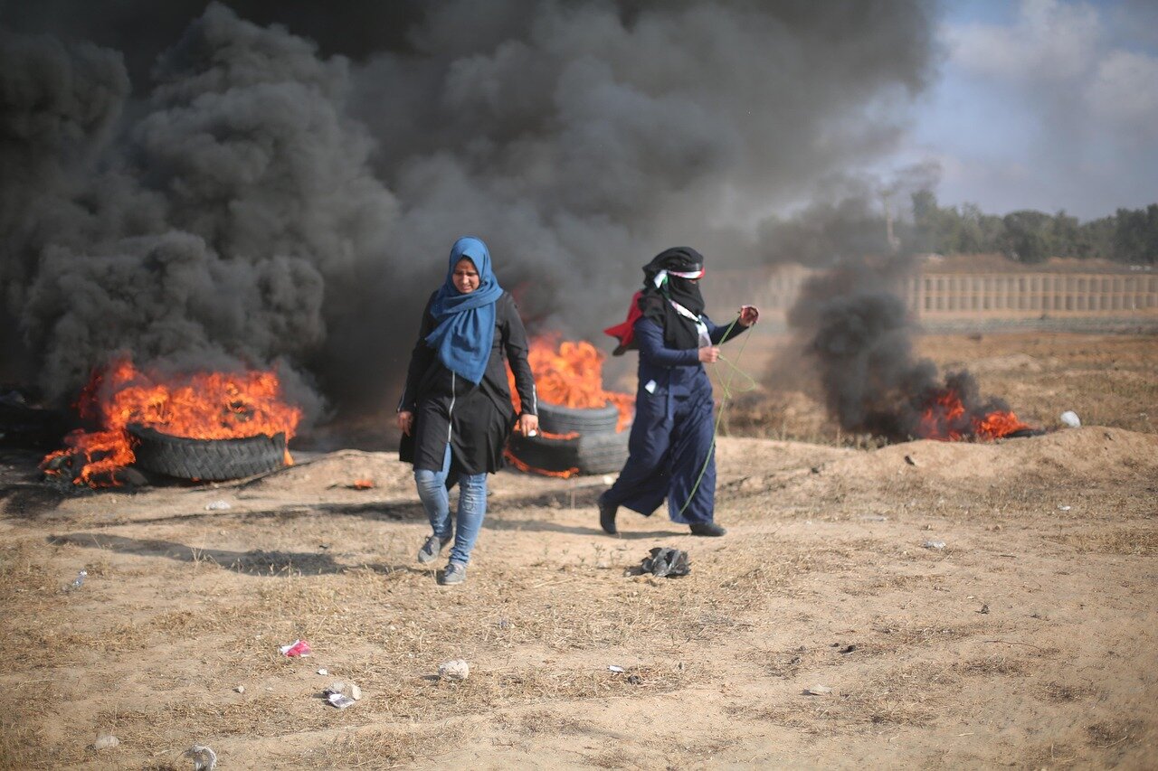 Overwhelmed medical staff treating injured civilians in a makeshift hospital, highlighting the urgent humanitarian crisis