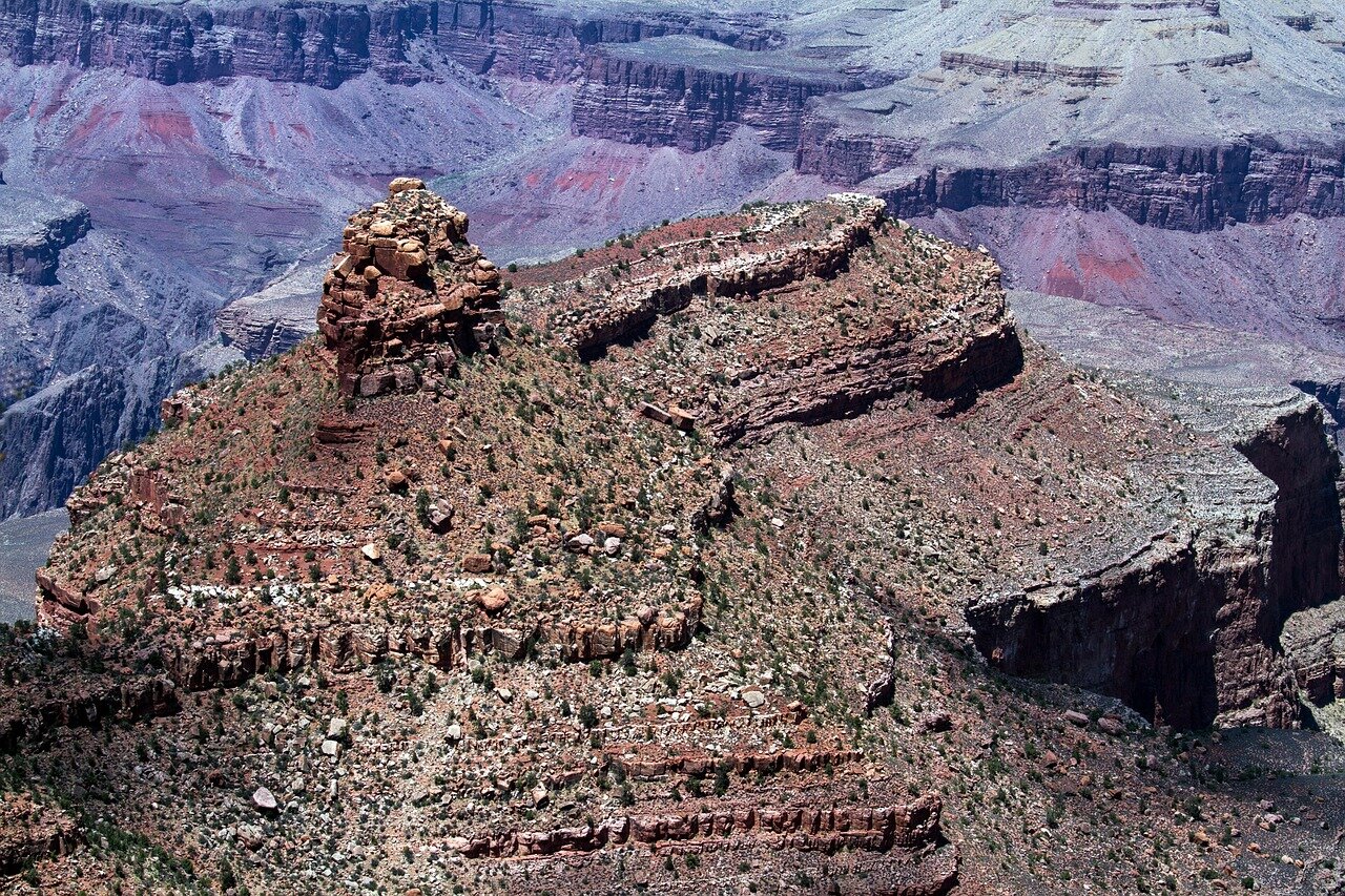 A view of the historic El Tovar Hotel, showcasing its unique architecture against the backdrop of the Grand Canyon landscape