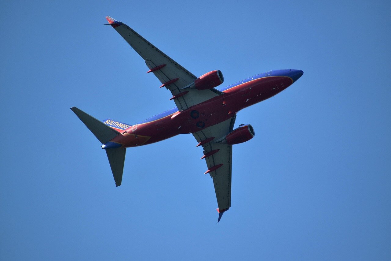 A group of airline employees engaged in a training session, emphasizing the importance of enhancing staff readiness to handle peak travel demands
