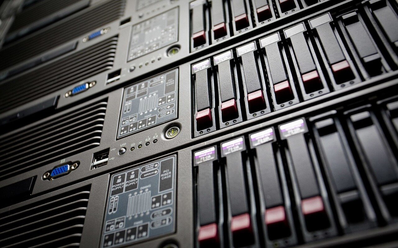 A technician inspects a compact data centre filled with servers and networking equipment, showcasing the shift towards smaller, energyefficient facilities in the tech industry.