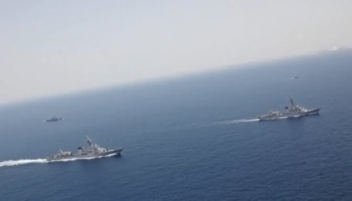 Iranian naval vessels conduct military drills in the Strait of Hormuz, showcasing their presence amid rising tensions over maritime security and oil supply concerns.