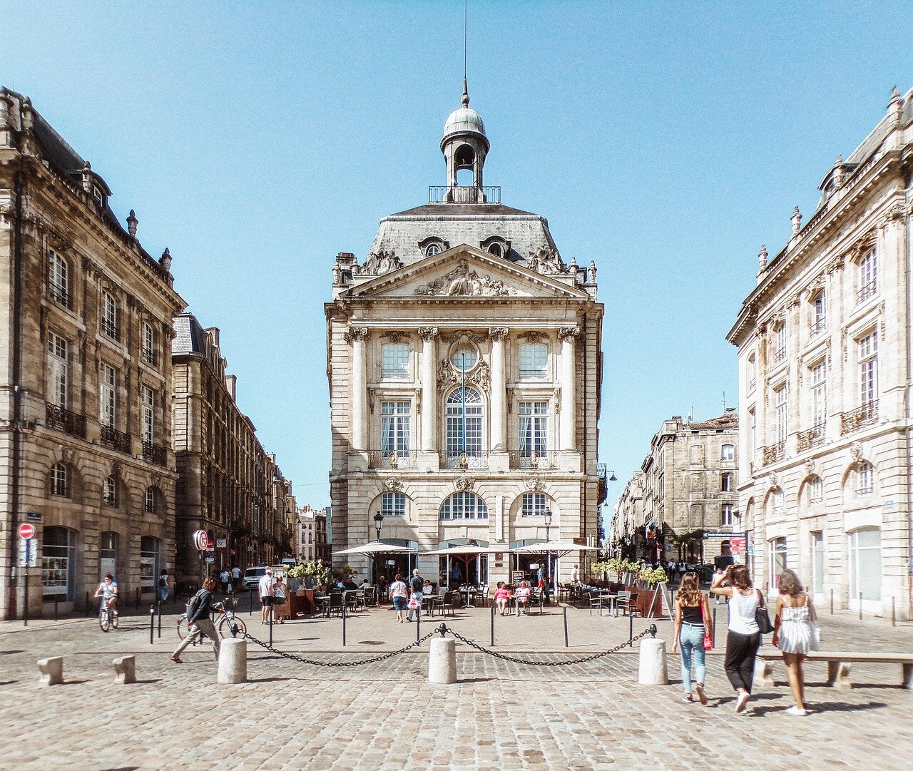 The iconic Bordeaux skyline serves as a backdrop for passionate supporters proudly wearing their team's colors during a home game