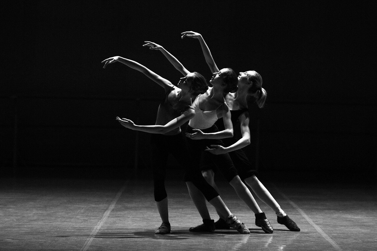 A rehearsal setting where dancers of various shapes and sizes collaborate, reflecting the growing acceptance of different body types in ballet