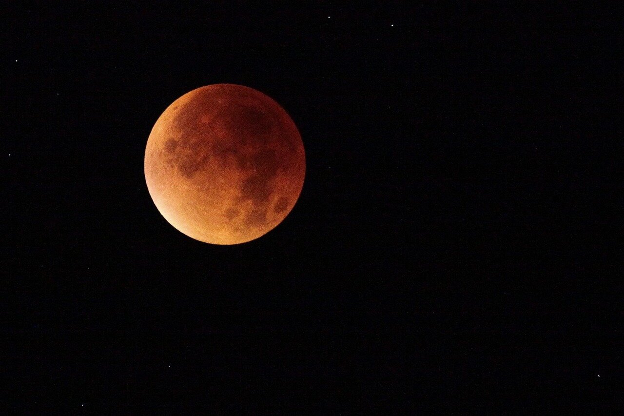A lively festival atmosphere in a northern Spanish town, where locals and tourists gather to celebrate the impending total solar eclipse with various activities and programs
