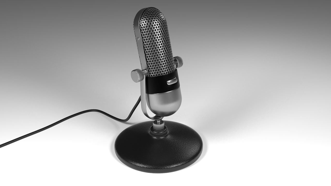 A vibrant community event featuring women speakers and podcasters, illustrating the impact of podcasts on promoting discussions about gender equality and social justice