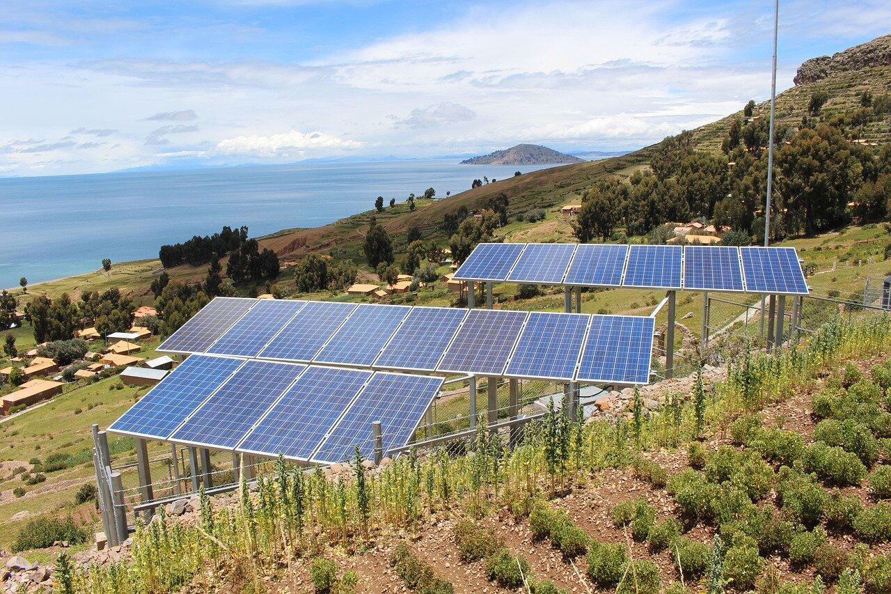 A homeowner inspects newly installed solar panels on their roof while discussing energy savings with a contractor.