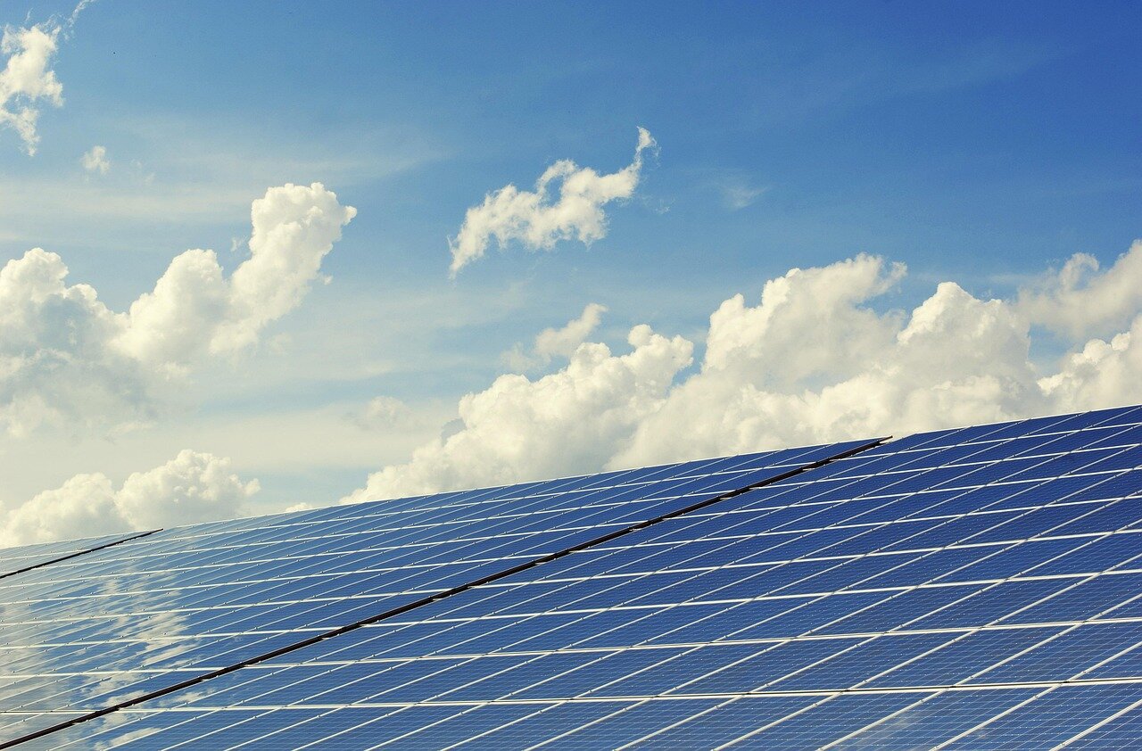 A family reviewing their energy bills while discussing the potential savings from installing solar panels, highlighting the financial motivations behind their decision