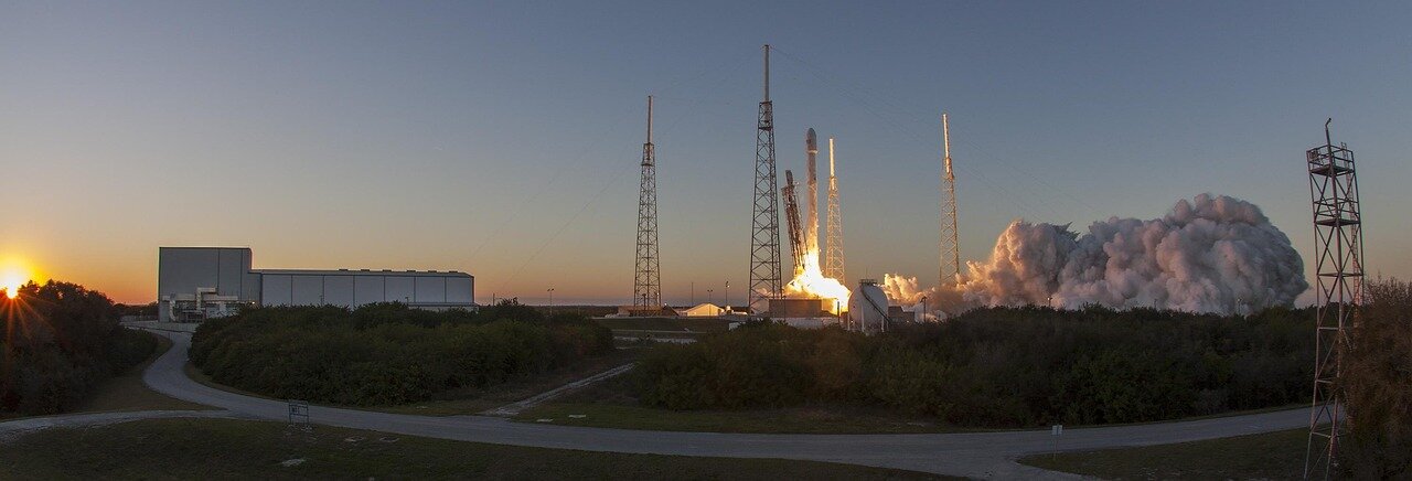 A bustling aerospace industry event where companies network and discuss the implications of the Starship delay