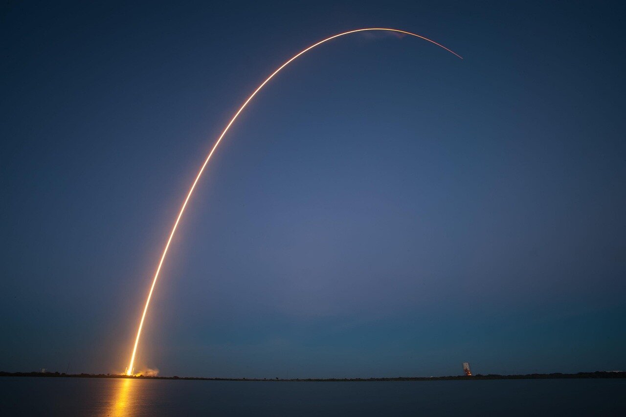 A dramatic view of the fiery explosion occurring shortly after the rocket's splashdown, illuminating the ocean's surface