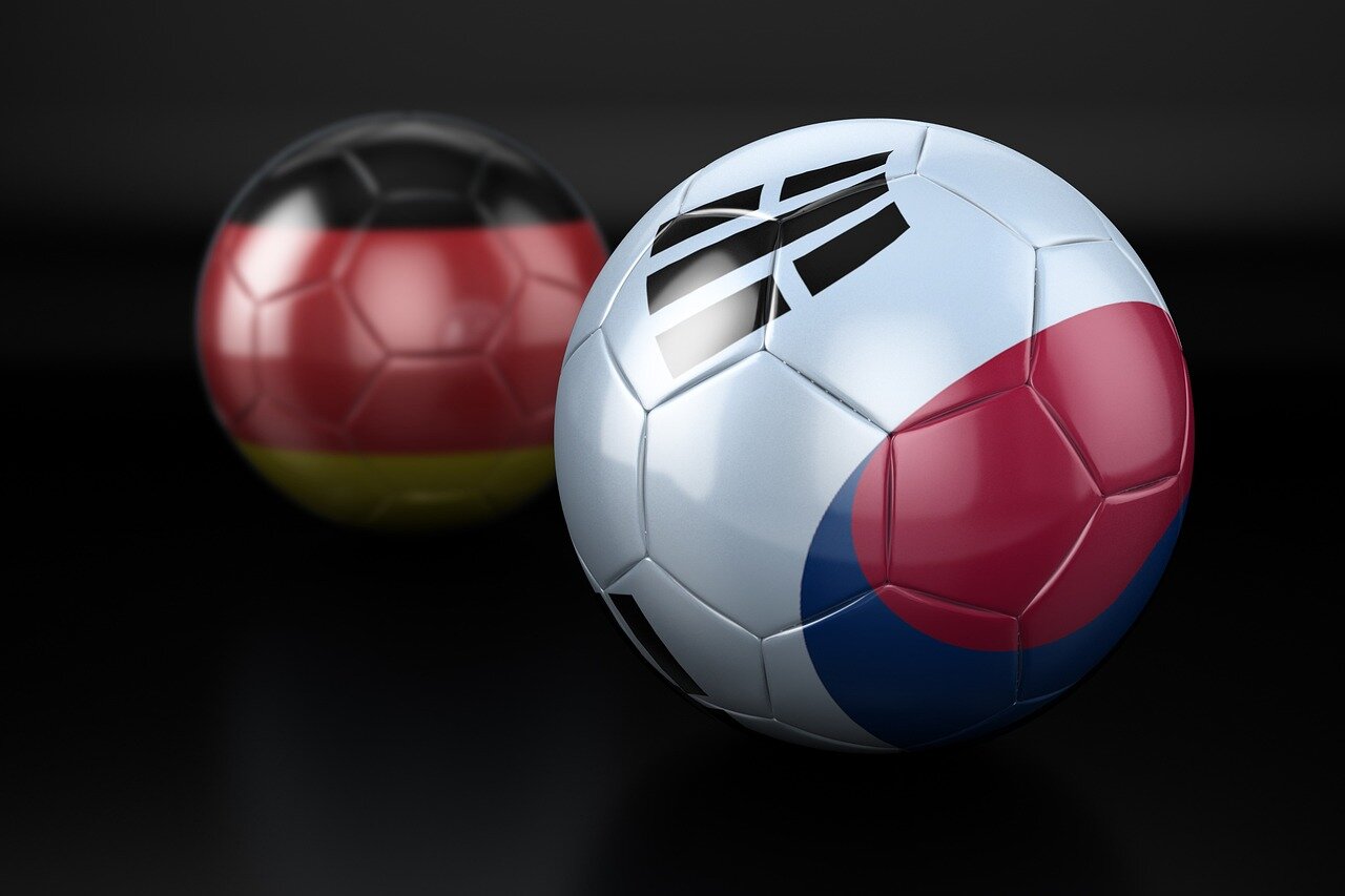A diverse group of players stands together, symbolizing the blend of experience and youth that many teams are embracing in their World Cup preparations