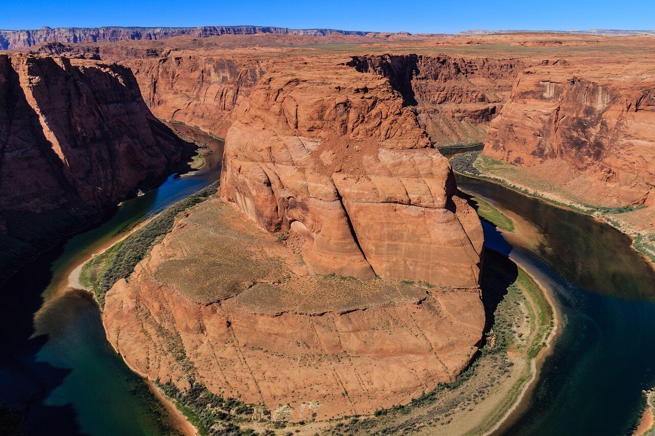 State officials gather around a conference table, engaged in intense discussions about water allocation as drought conditions threaten the Colorado River's resources.