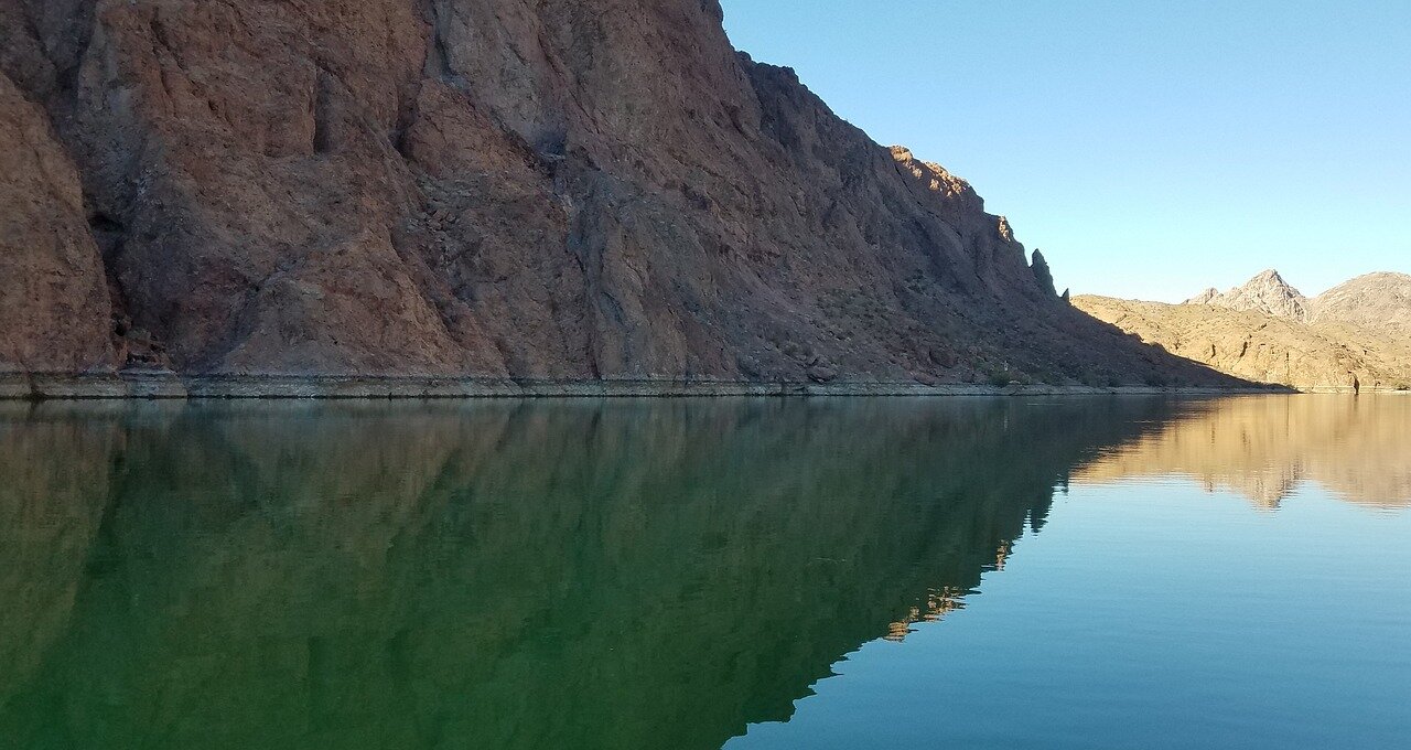 A farmer inspecting parched fields, illustrating the challenges faced by agricultural producers as they adapt to dwindling water resources from the Colorado River