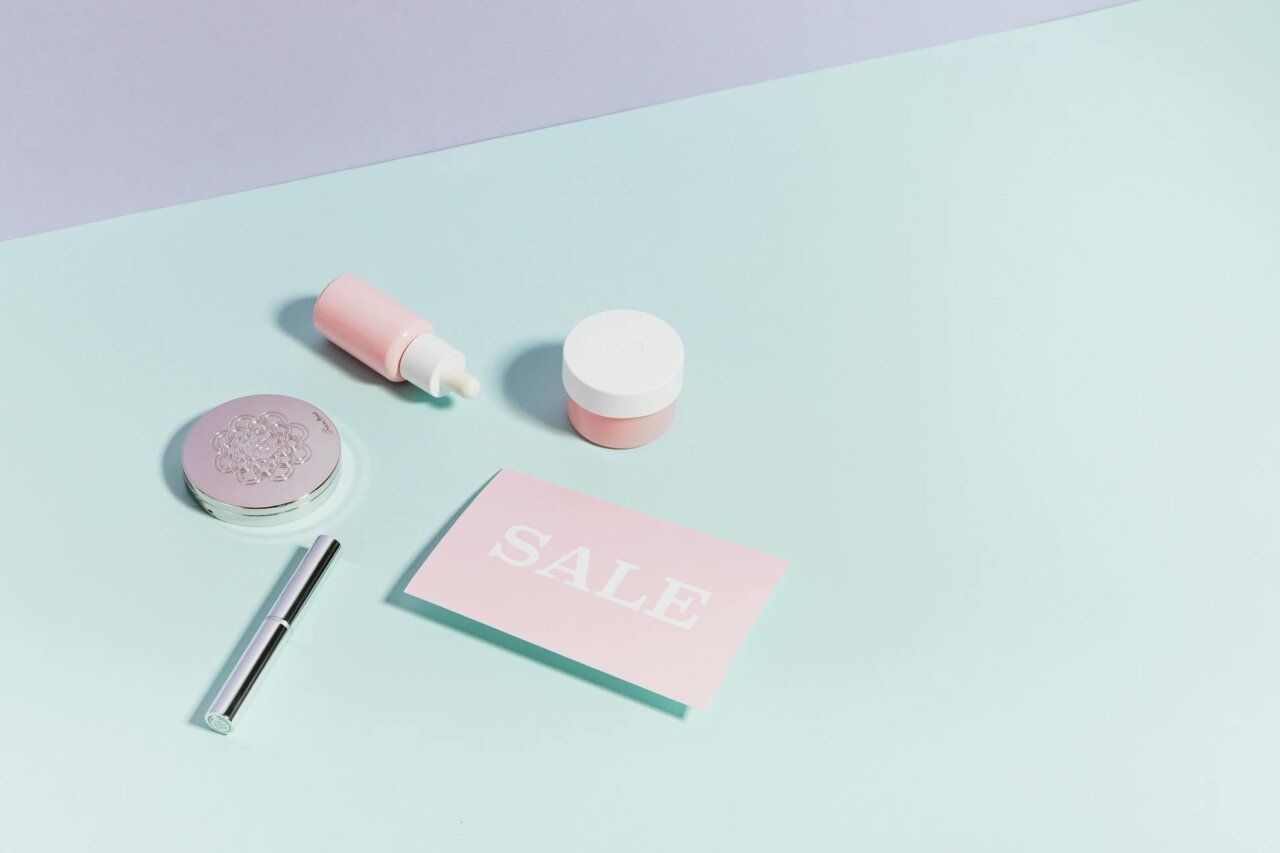A stressed young woman surrounded by skincare products, representing the financial and psychological burden of cosmeticorexia