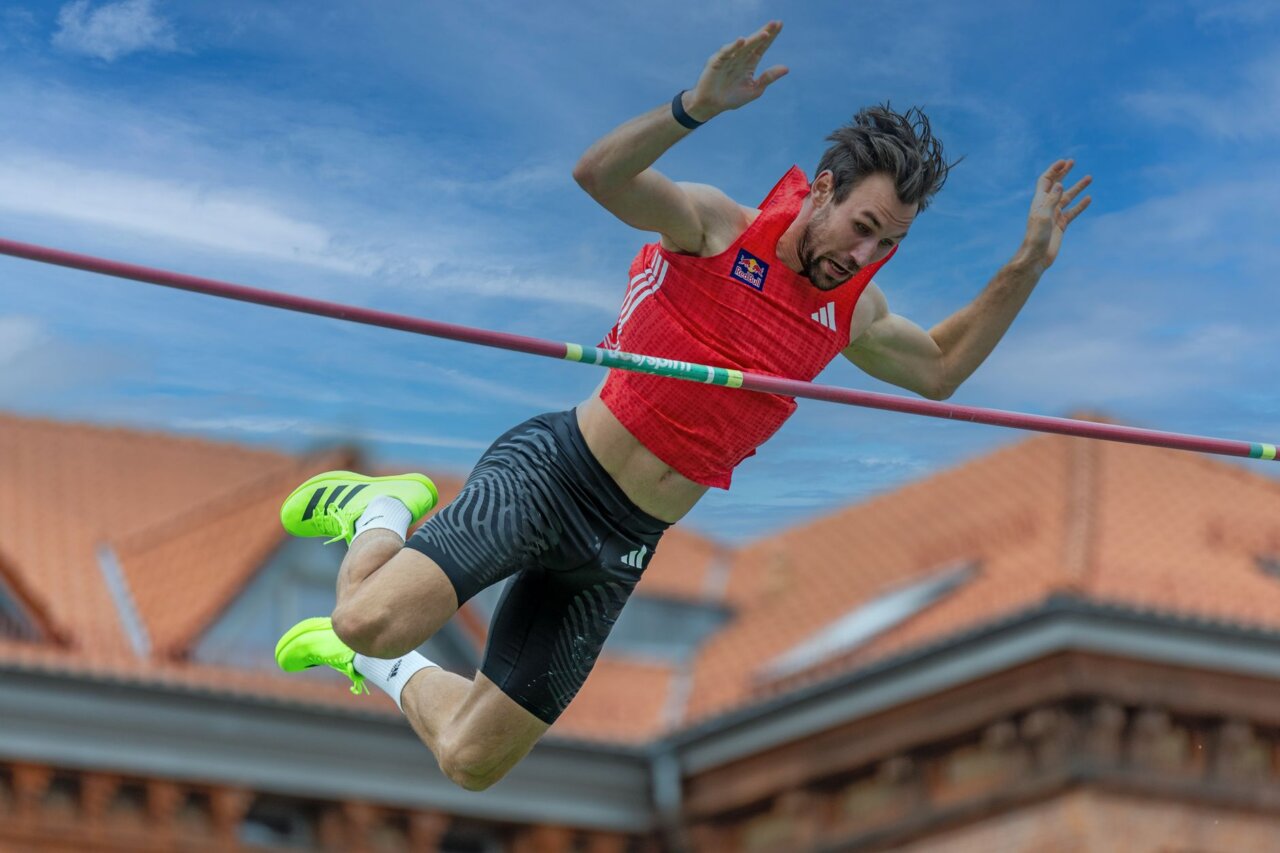 Armand Duplantis looks dejected after failing to clear a height during a pole vault competition in Lafayette, Louisiana, as a crowd of fans watches in surprise.