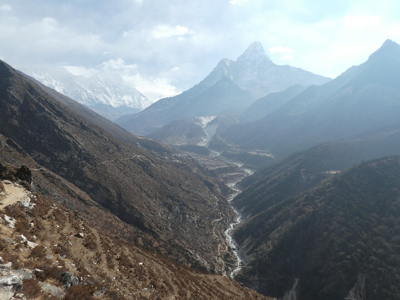 Tenzing Sherpa, a guide previously presumed dead, is seen crawling down the icy slopes of Mount Everest amidst a search operation by rescue teams and fellow climbers.