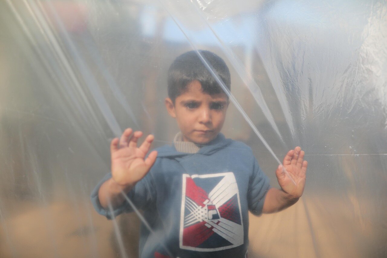A child receiving emergency treatment, highlighting the urgent medical needs of vulnerable populations affected by the conflict