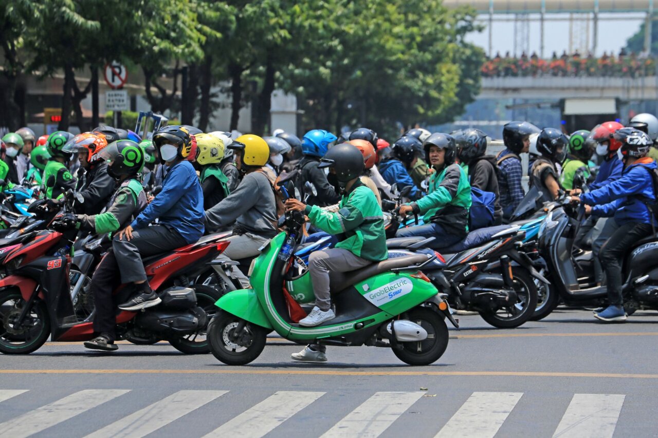 A bustling urban street in Indonesia, showcasing the growing demand for ridehailing and delivery services that Gojek provides