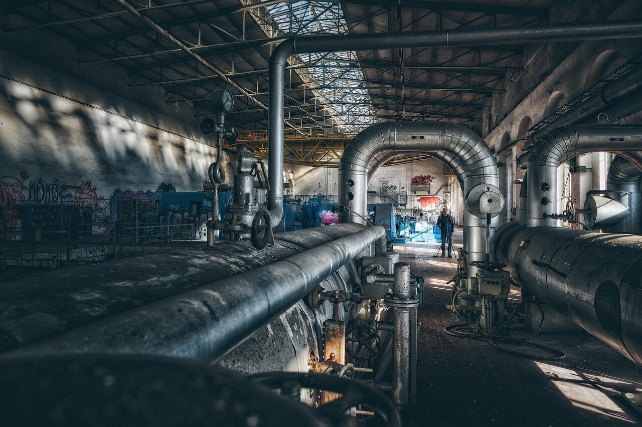 An overview of the factory floor, filled with advanced machinery used in the production of specialized fabrics for the aerospace industry