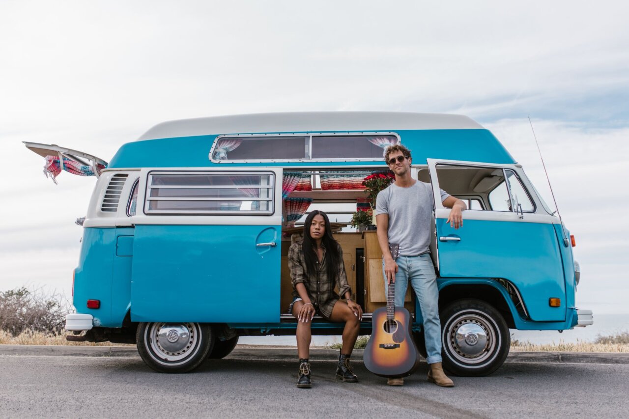 Khruangbin and Alok are seen collaborating in a vibrant studio, surrounded by musical instruments and sound equipment, as they discuss the impact of sound on human emotions and wellbeing.