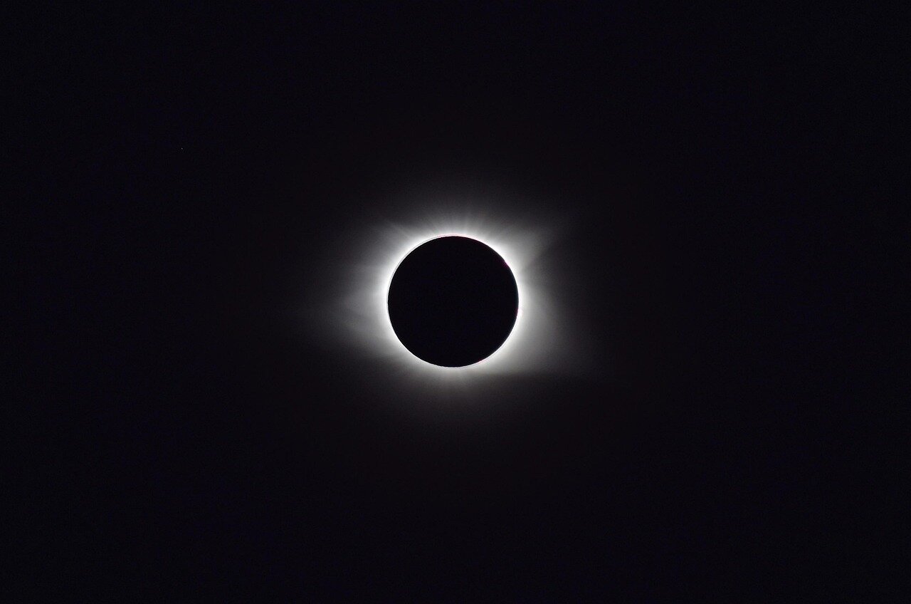 Scientists observing the super new moon through telescopes, highlighting its importance for research on lunar effects and tidal patterns