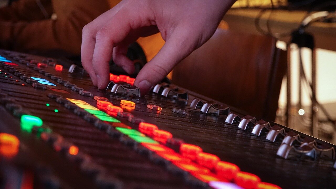 A composer working on a digital music software interface, illustrating the technological advancements impacting musical theater production