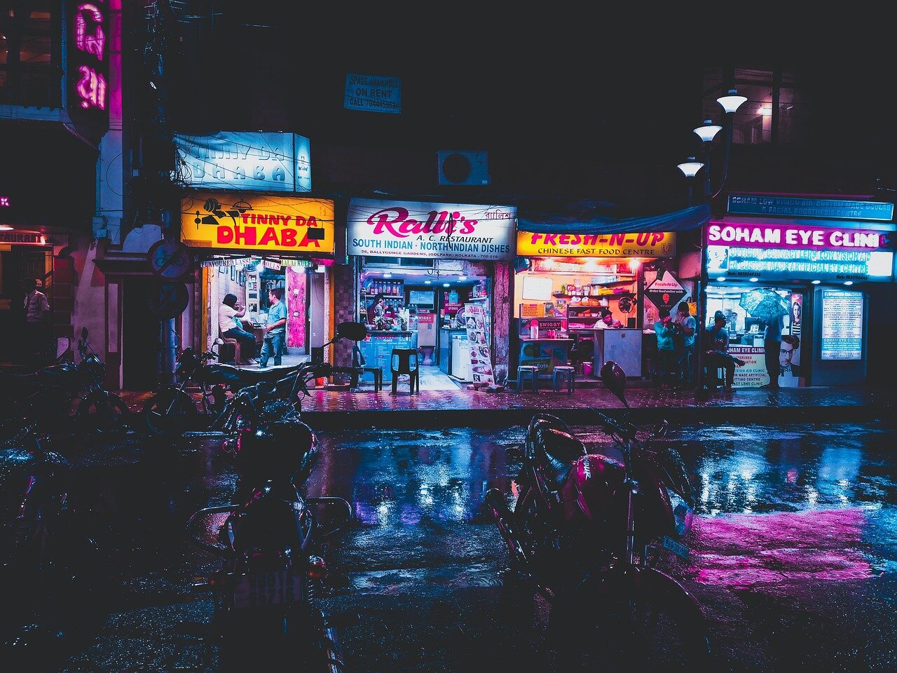 A vibrant scene capturing the bustling atmosphere of a local cinema, filled with film enthusiasts ready to engage with Basbeth's storytelling