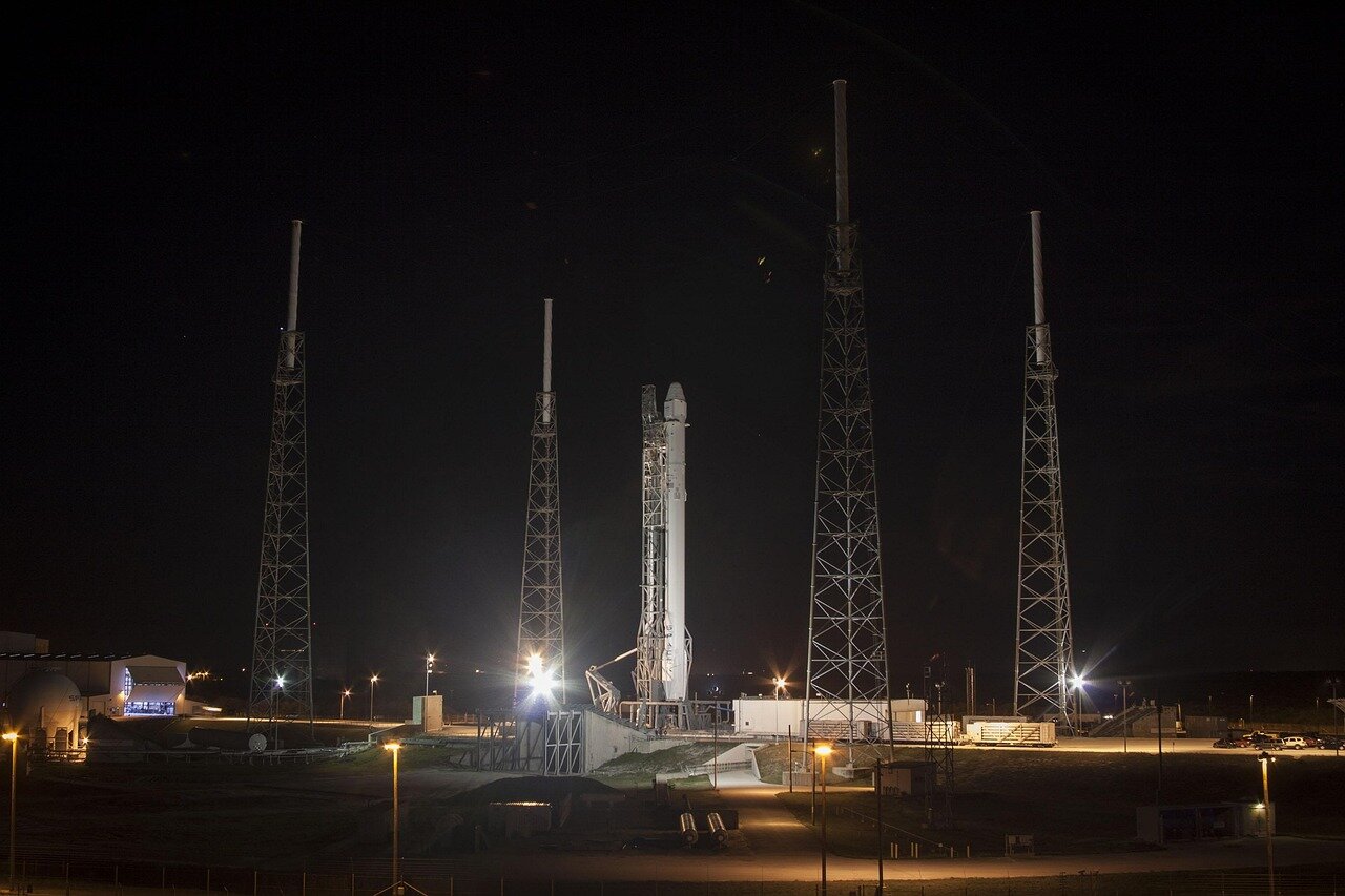 A SpaceX team celebrating the successful launch of the Falcon 1, marking a pivotal moment in the company's journey towards space exploration