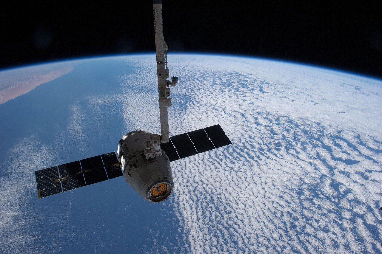 Representatives from SpaceX and NASA shaking hands, illustrating the strong partnership that has been vital for securing government contracts