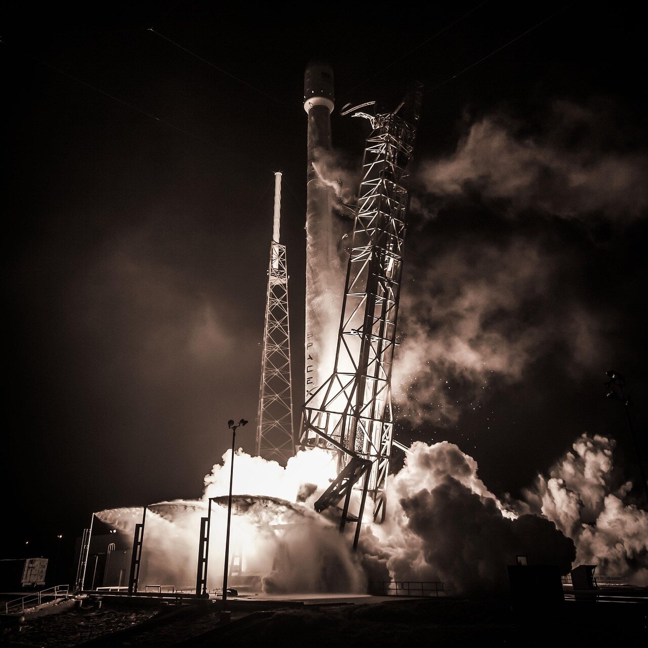 Engineers working on a SpaceX spacecraft, showcasing the innovative efforts behind the development of reusable rocket technology that drives down launch costs
