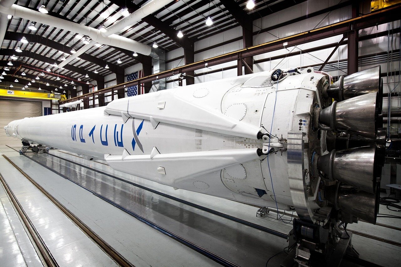 Investors and industry experts engaging in discussions about the potential impact of SpaceX's public offering on the aerospace sector and space exploration