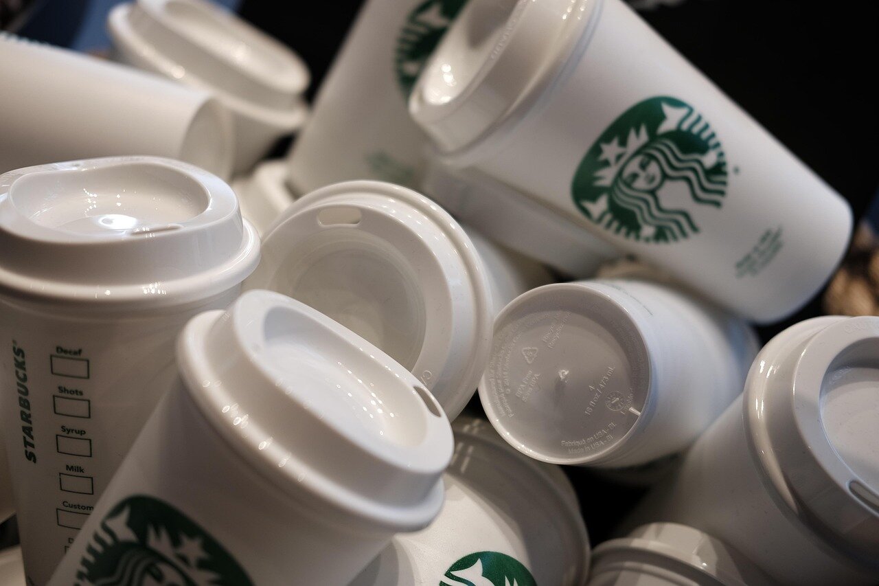 South Korean customers expressing mixed reactions on social media regarding Starbucks' decision to conduct employee training on historical issues
