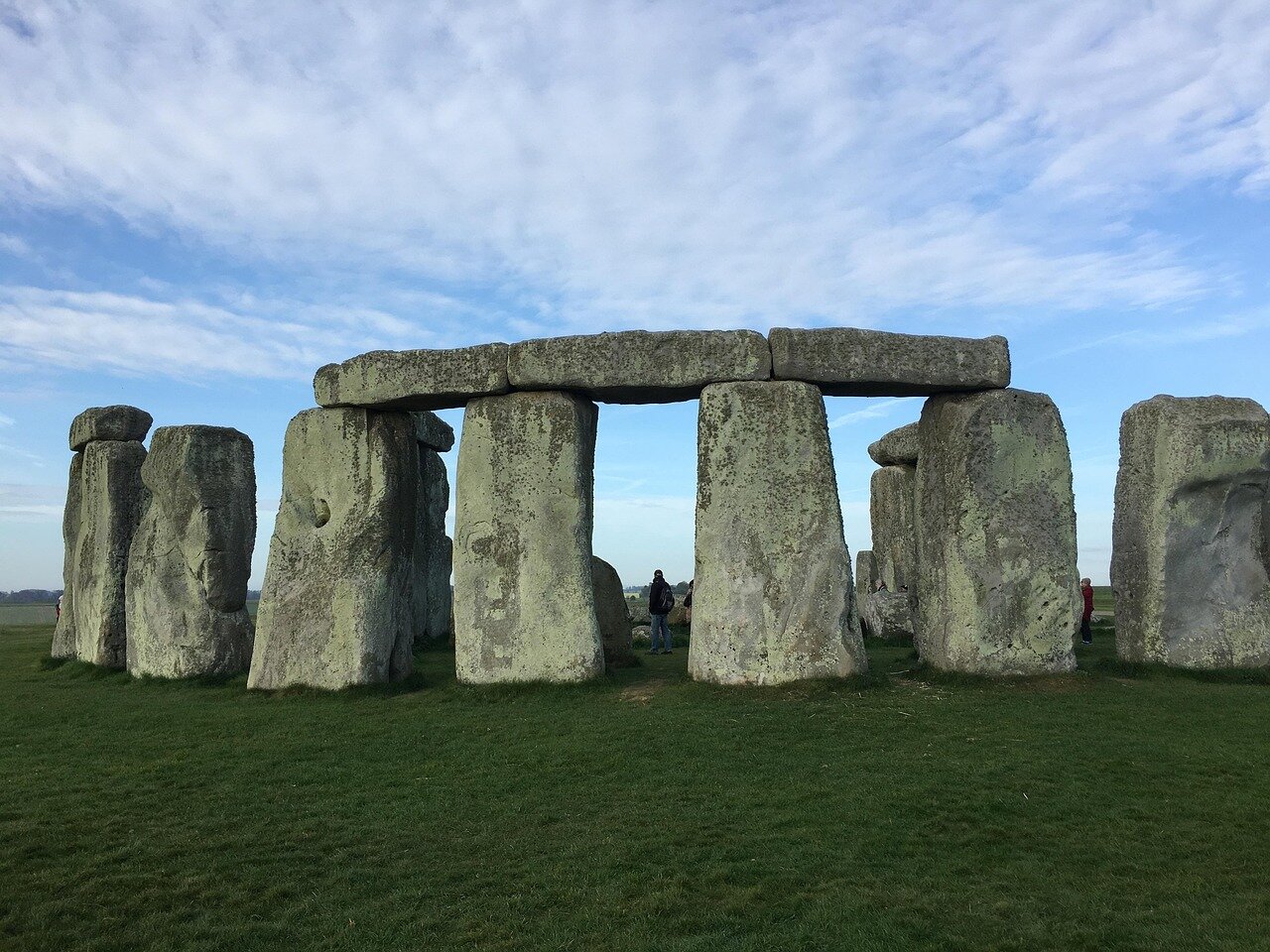 Archaeologists examine a circular formation of standing stones recently uncovered near Stonehenge, highlighting its potential ceremonial significance in Neolithic Britain.