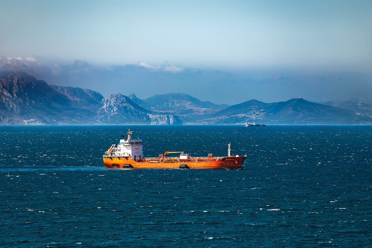 An oil tanker idling in the Strait of Hormuz, illustrating the significant disruptions to global shipping routes caused by geopolitical tensions