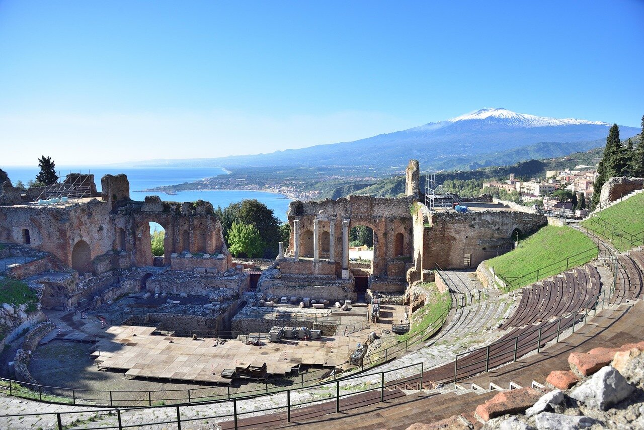 The ancient Greek theater in Taormina is filled with attendees as the Taormina Film Festival opens with a screening of House of the Dragon Season 3, showcasing the stunning backdrop of Mount Etna.