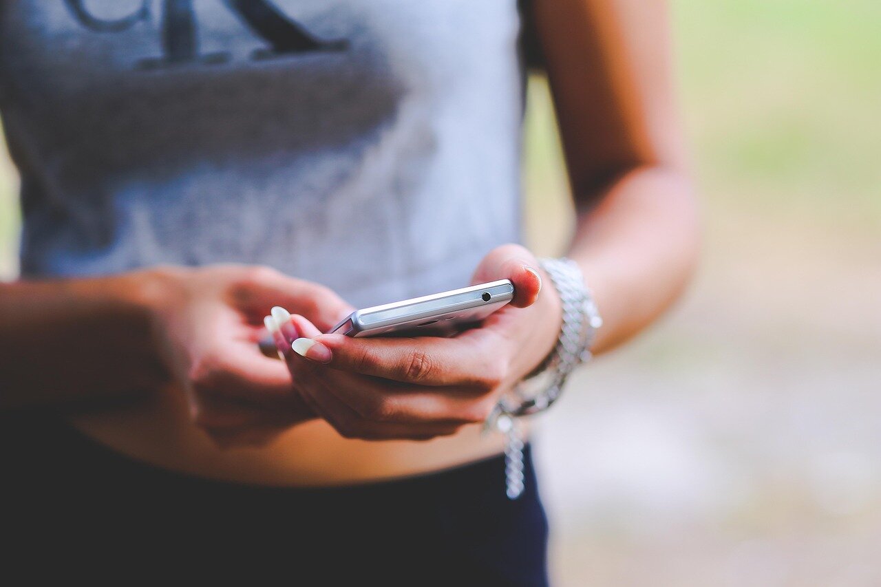 A closeup of a smartphone with a detailed product description, emphasizing the importance of transparency in the used tech market