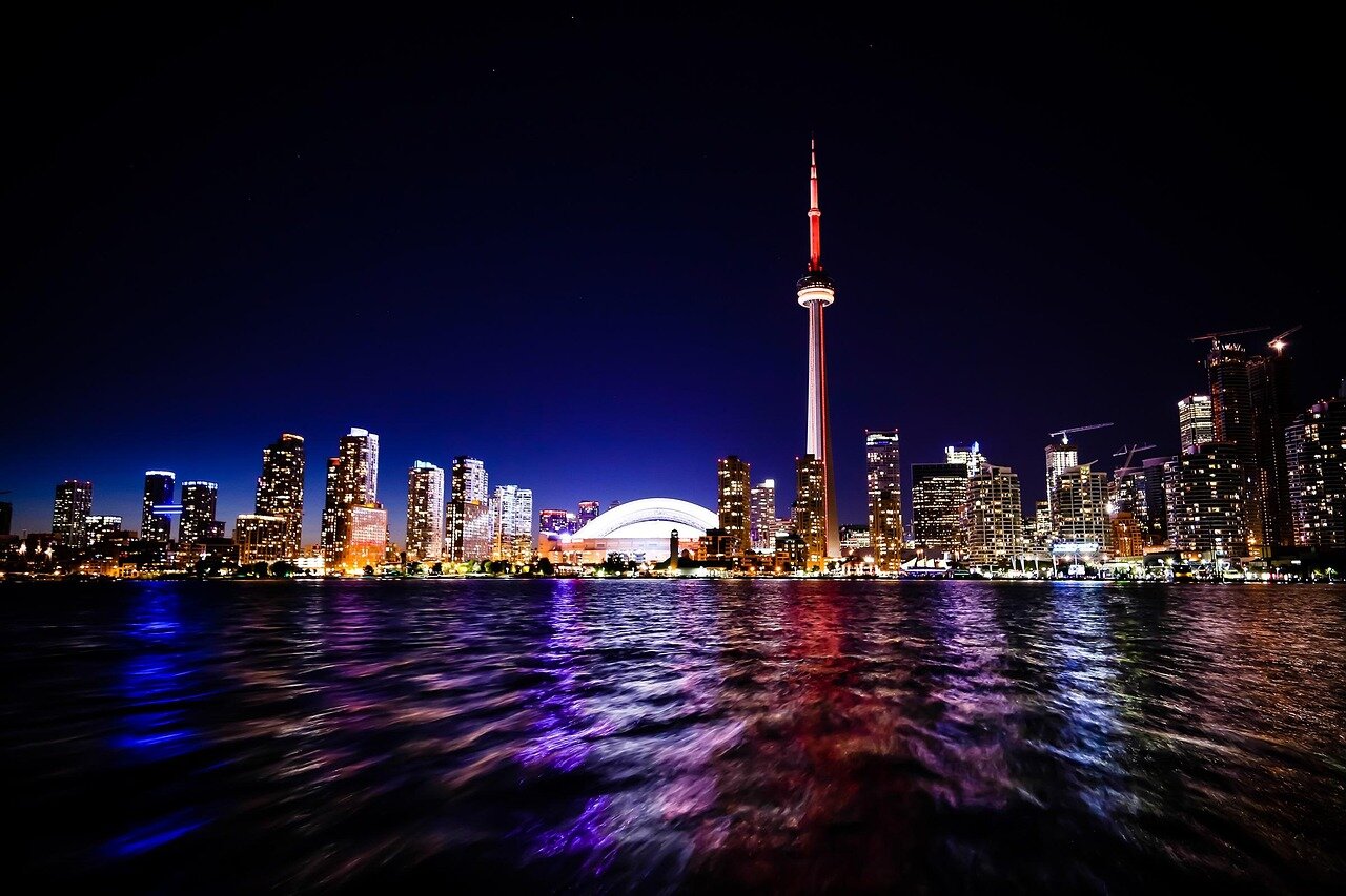 A panoramic view of the Toronto waterfront featuring the floating convenience store, highlighting the integration of commerce with the city's natural landscape