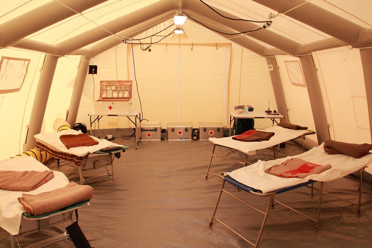 Inside a modern cancer care centre, a patient receives radiation therapy while a healthcare professional monitors the treatment process