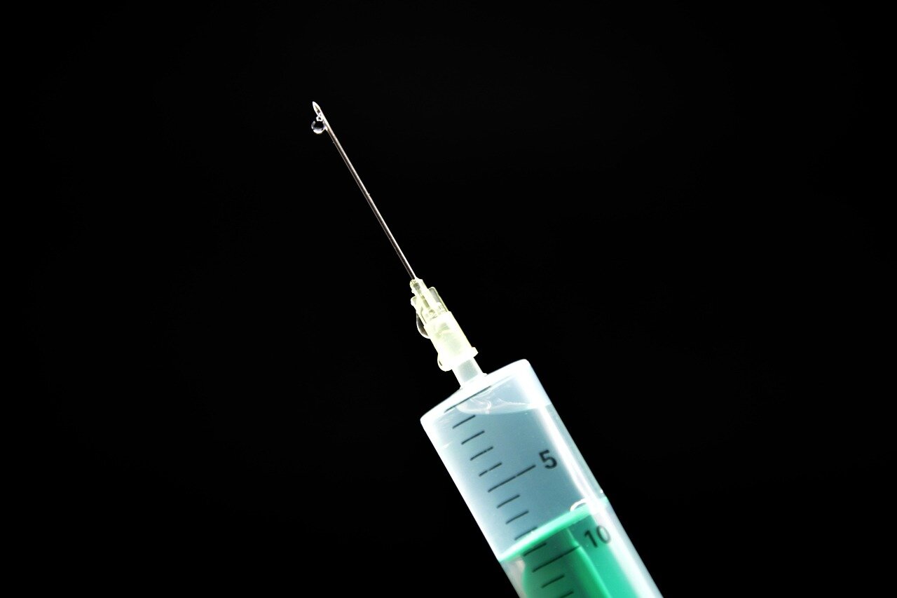A healthcare provider administering the Meningitis B vaccine to a young adult, showcasing the proactive measures being taken to prevent serious health complications