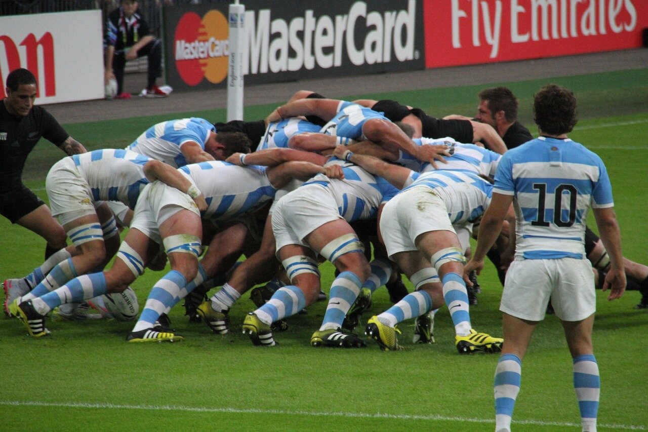 A closeup of a rugby player celebrating a try, with a backdrop of empty seats, illustrating the stark contrast between past enthusiastic crowds and the current decline in attendance at the Challenge Cup final