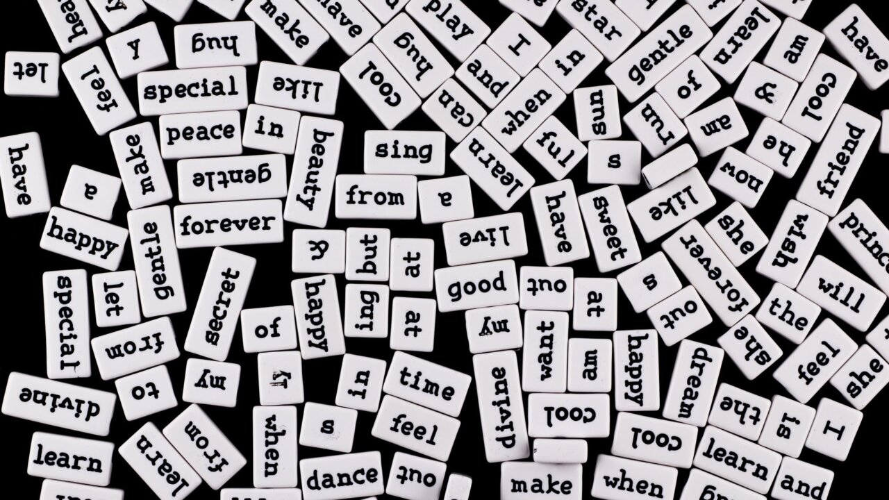 A diverse group of players gathered around a table, sharing tips and strategies for mastering Wordle, reflecting the collaborative spirit of the game's community