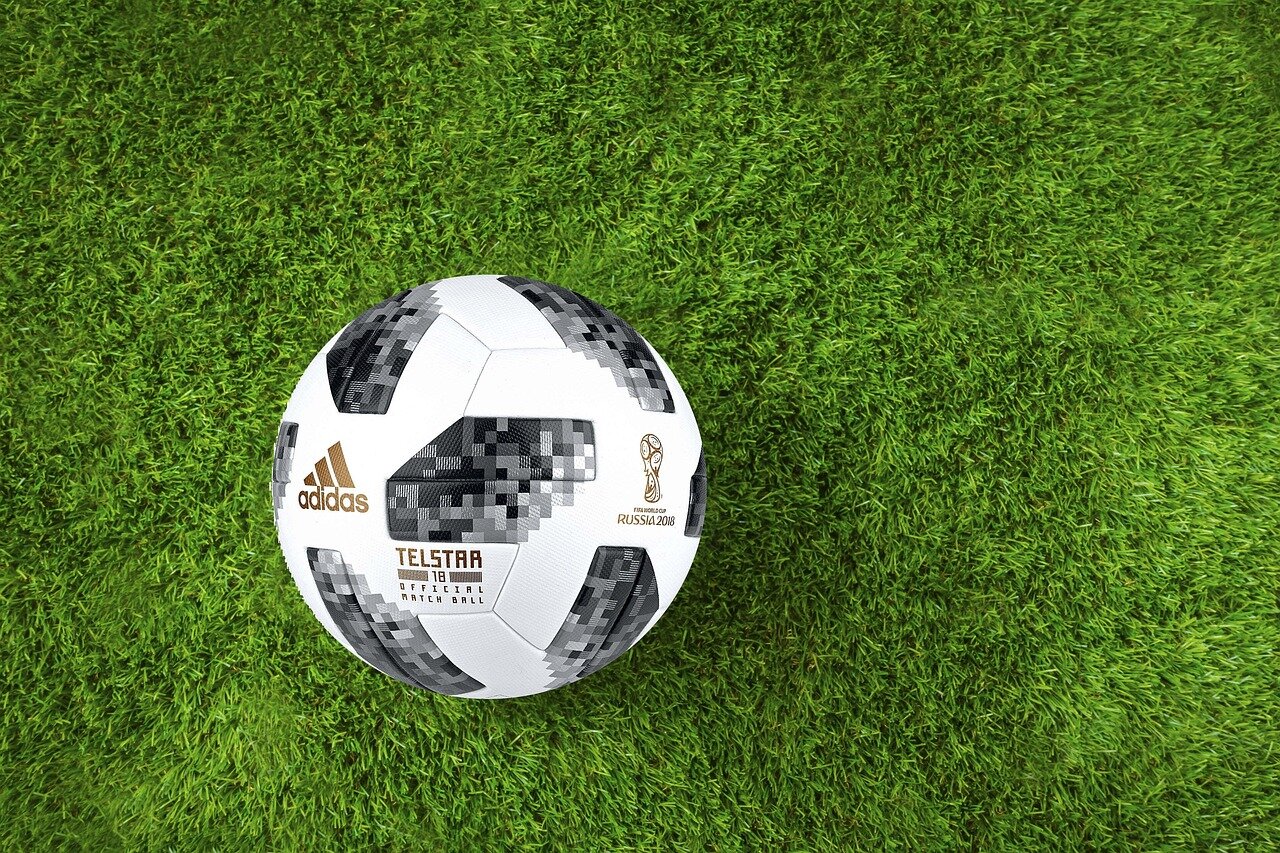 A vibrant crowd cheering passionately at the World Cup match, highlighting the global excitement surrounding the tournament