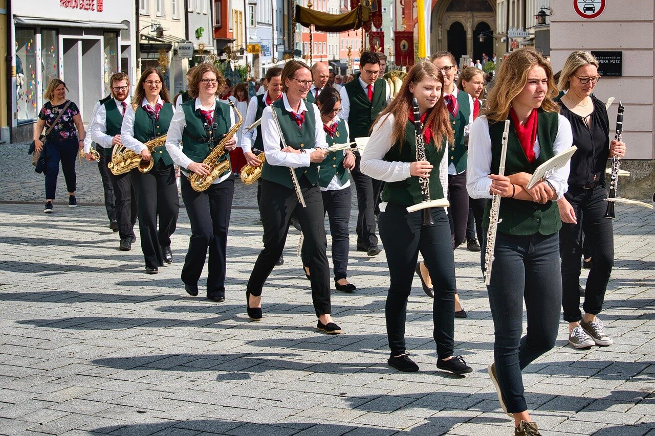 Musicians of varying skill levels coming together on stage, embodying the band's philosophy of embracing chaos and imperfection in their collective musical expression