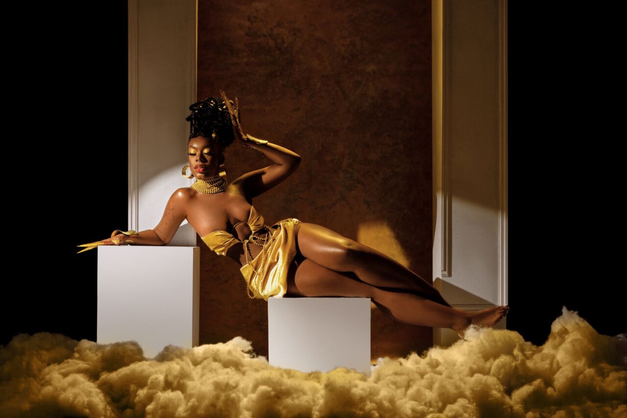 A bustling music studio scene where Beyoncé is seen collaborating with producers, reflecting her creative process behind the new song