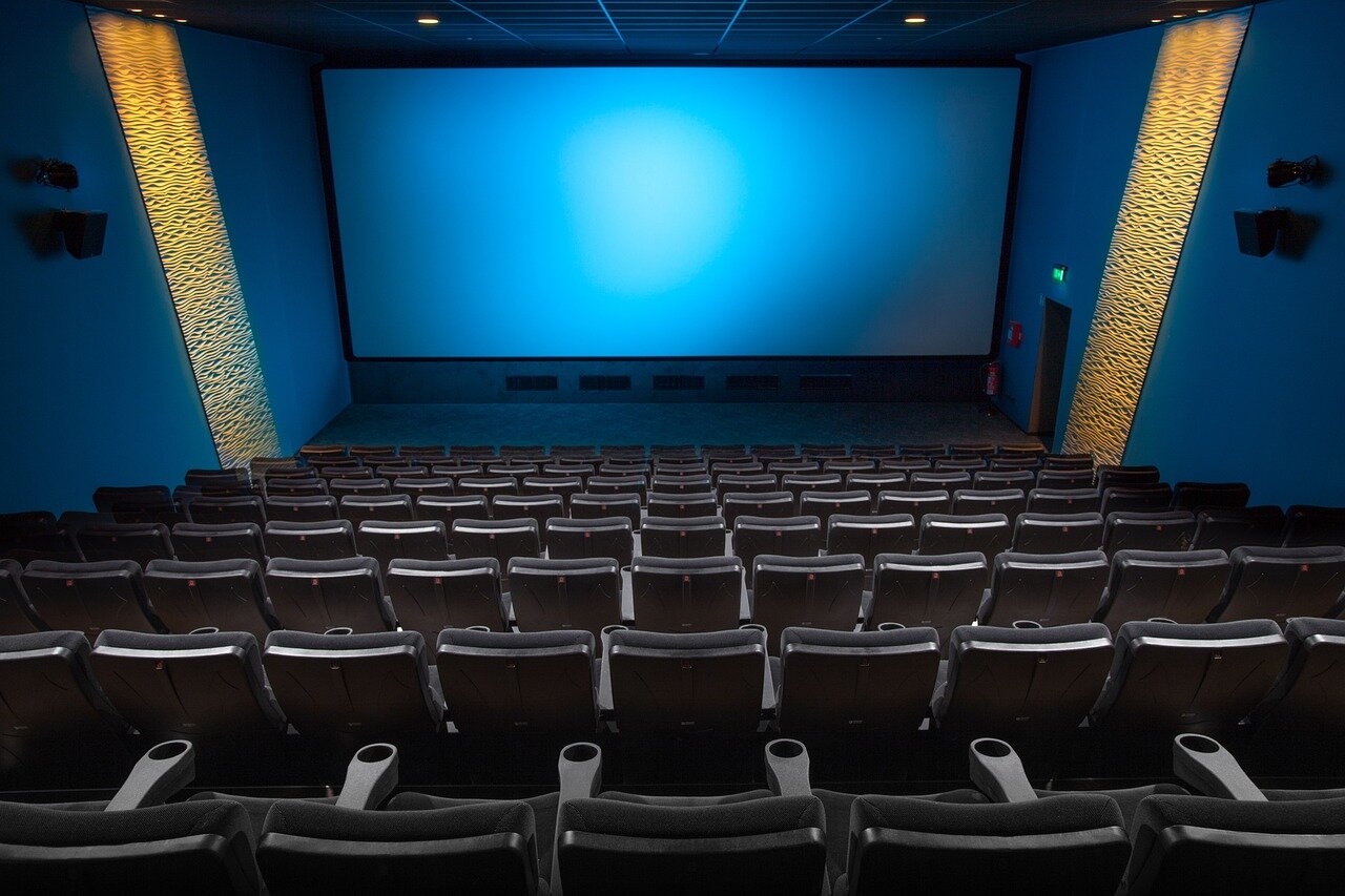 A vibrant scene from a film festival, filled with banners and posters promoting independent films, emphasizing the celebration of artistic expression and creativity