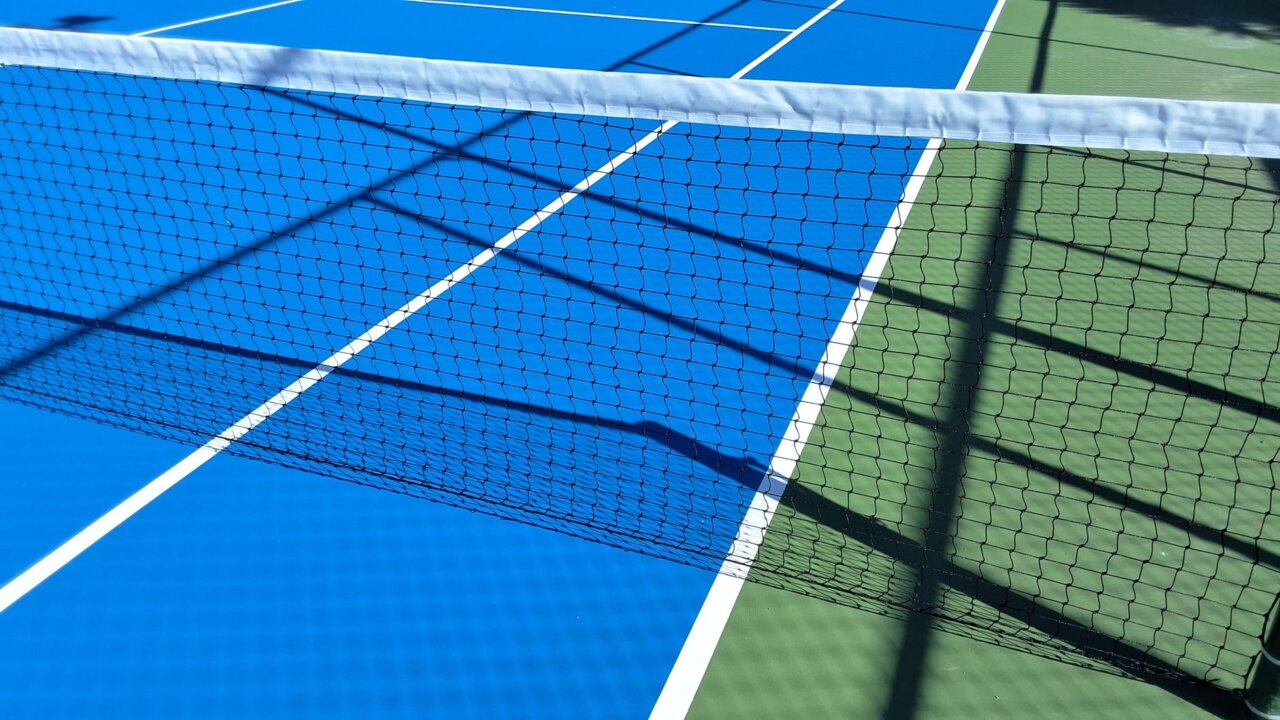 Djokovic skillfully returns a powerful serve, showcasing his tactical prowess on the grass courts of the All England Club