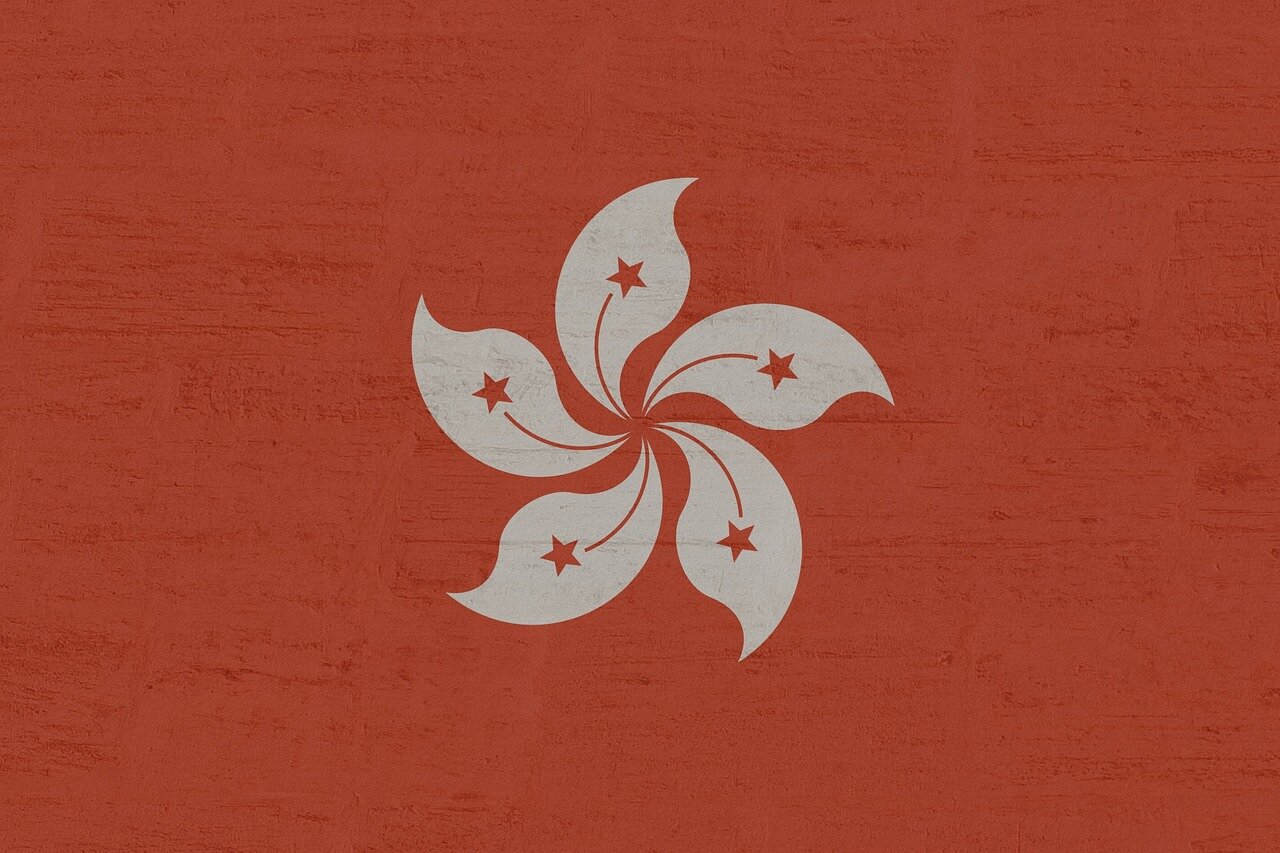 A group of writers and activists in discussion, inspired by Lam's legacy, brainstorming ways to continue advocating for free expression and literary freedom in a challenging environment
