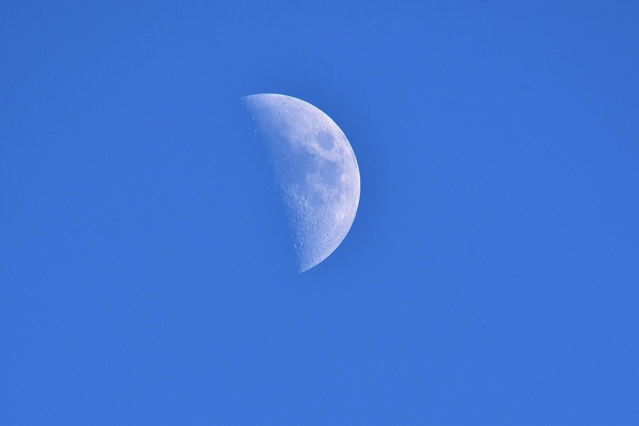 A picturesque landscape bathed in moonlight, showcasing the connection between nature and the cultural heritage surrounding the Strawberry Moon