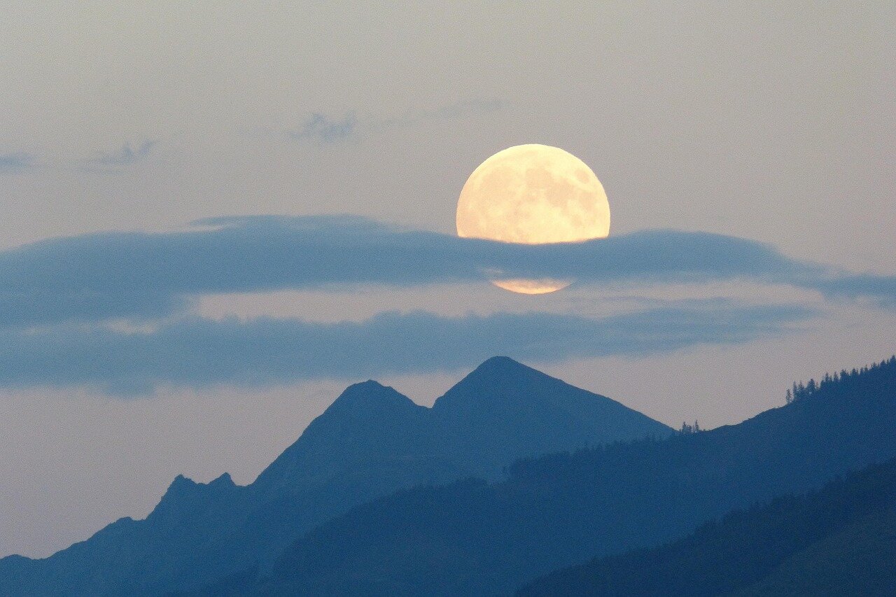A picturesque rural landscape illuminated by the full moon, showcasing the connection between nature and agricultural traditions during the Strawberry Moon